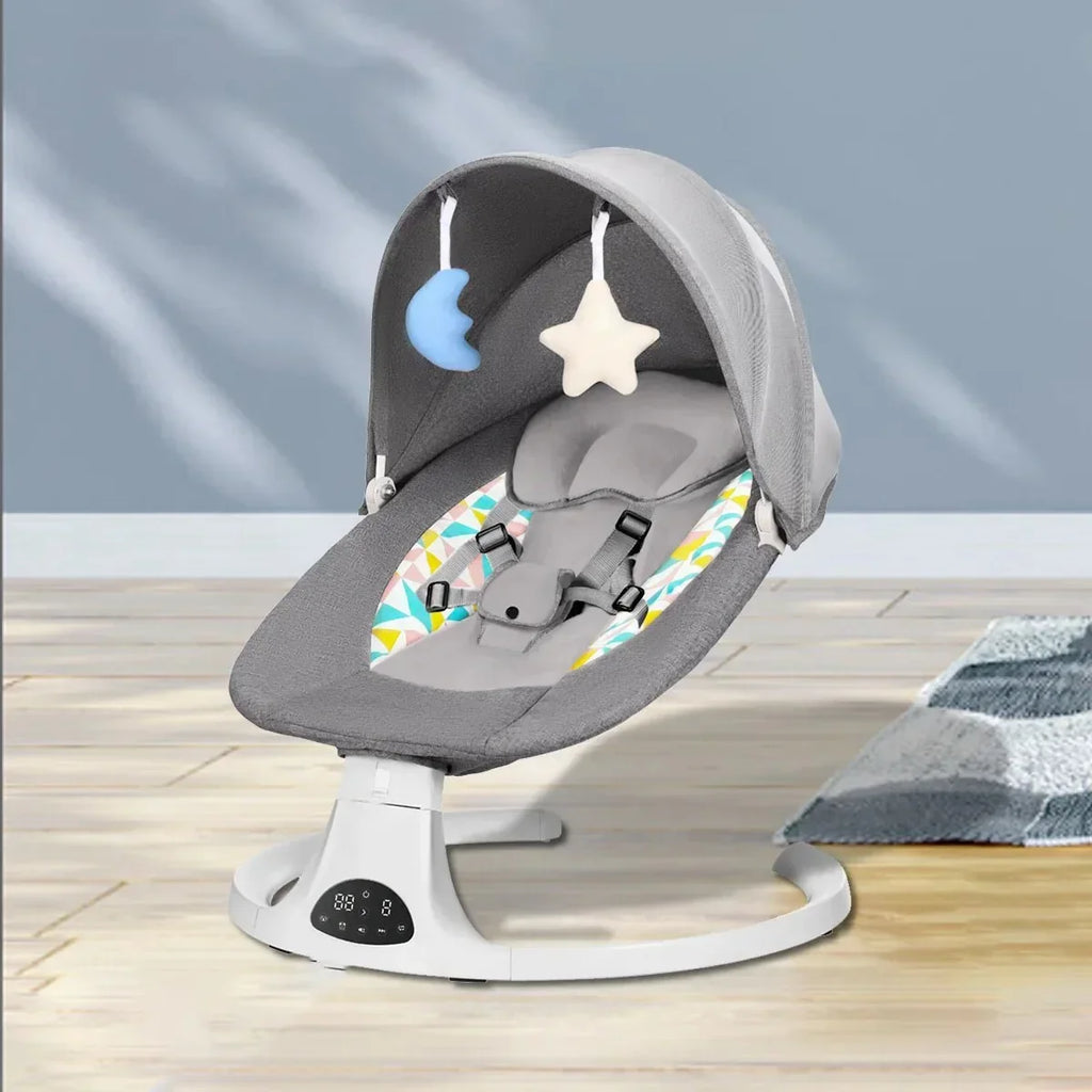 Modern gray baby rocker with canopy, hanging moon and star toys, and safety harness on wooden floor