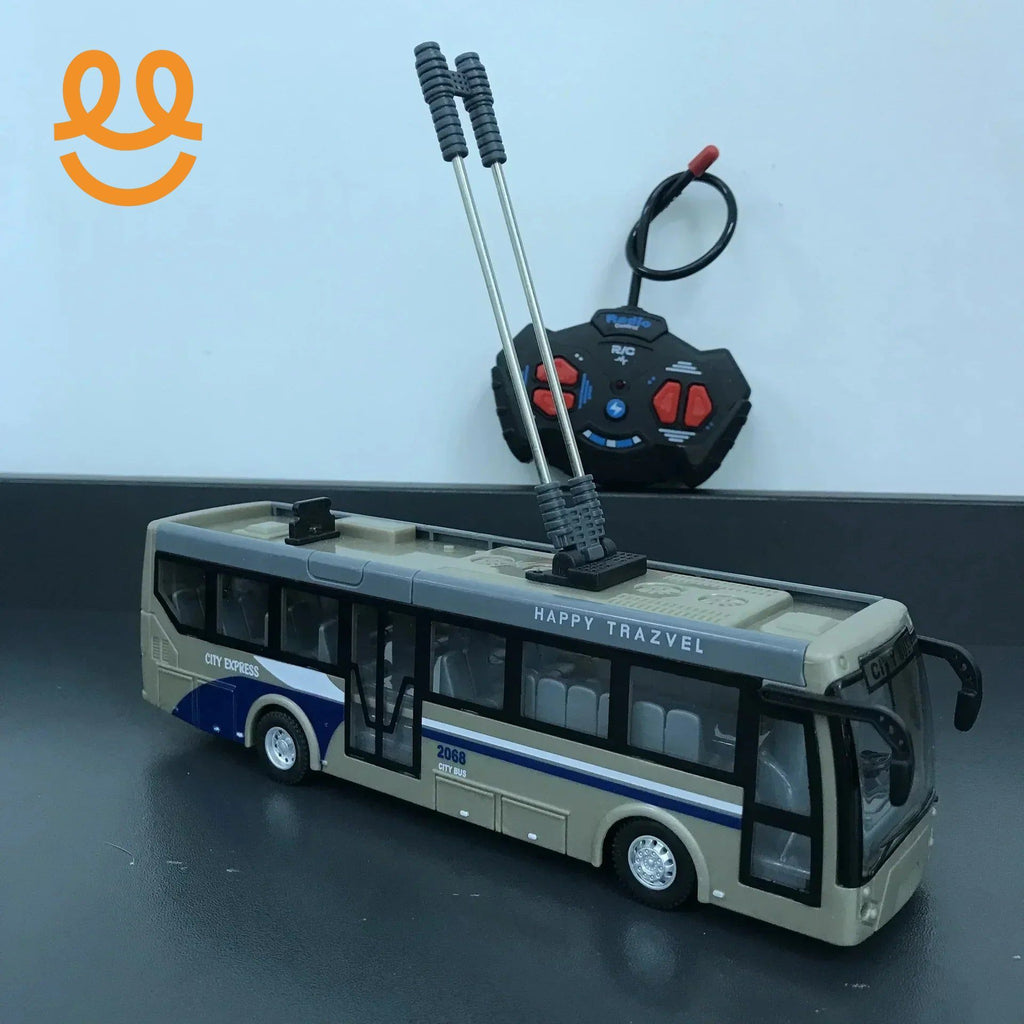 Beige and blue remote control city bus toy with dual antennas and black controller on black surface