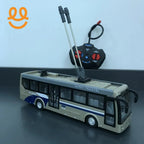 Beige and blue remote control city bus toy with dual antennas and black controller on black surface