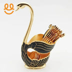 Elegant gold and black swan-shaped toothpick holder with decorative toothpicks