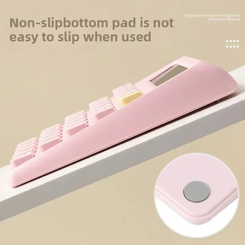 Pink mechanical keyboard with non-slip bottom pad shown on tilted white surface, highlighting anti-slip feature