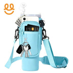 light blue crossbody bag with pockets holding phone, credit cards, keys, dollar bills, and a white cloud-shaped earphone case