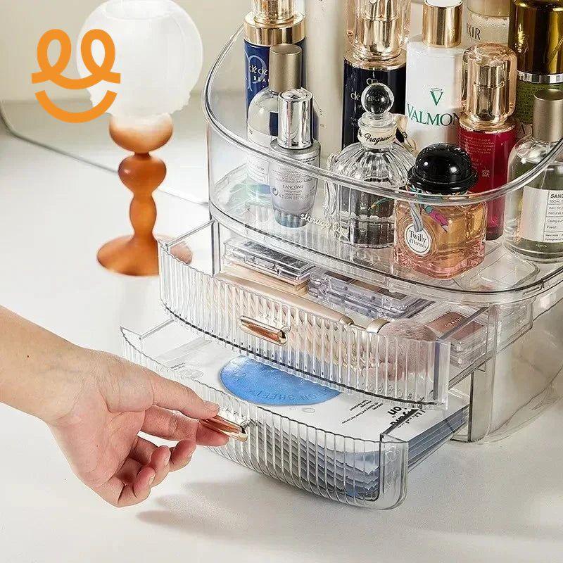 Clear acrylic makeup organizer with perfume bottles, cosmetics, and open drawers on white surface