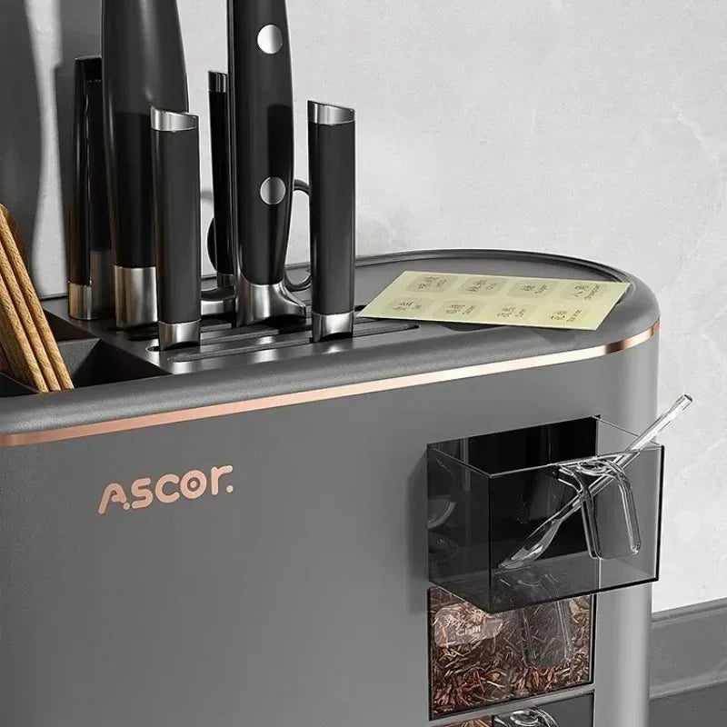 Ascor black kitchen knife set with block and attached transparent spice containers on grey countertop
