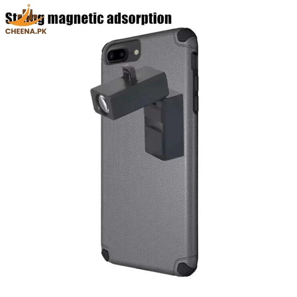 Black magnetic phone projector attached to the back of a grey textured phone case