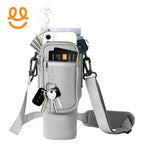 Grey crossbody water bottle holder with front pocket holding credit card, phone, keys, and cash