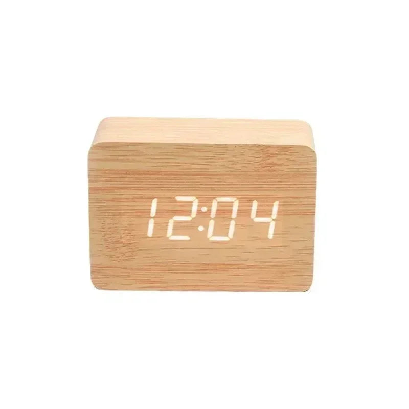 modern wooden digital alarm clock displaying 12:04 with white LED numbers on light wood grain