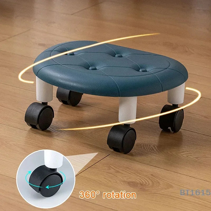 Blue cushioned rolling stool with 360-degree rotating black caster wheels on wooden floor