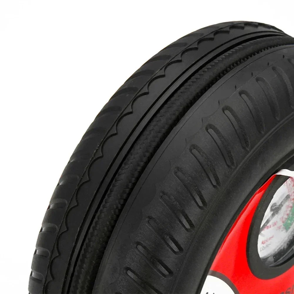 Close-up of black rubber tire with detailed treads and red wheel rim on white background