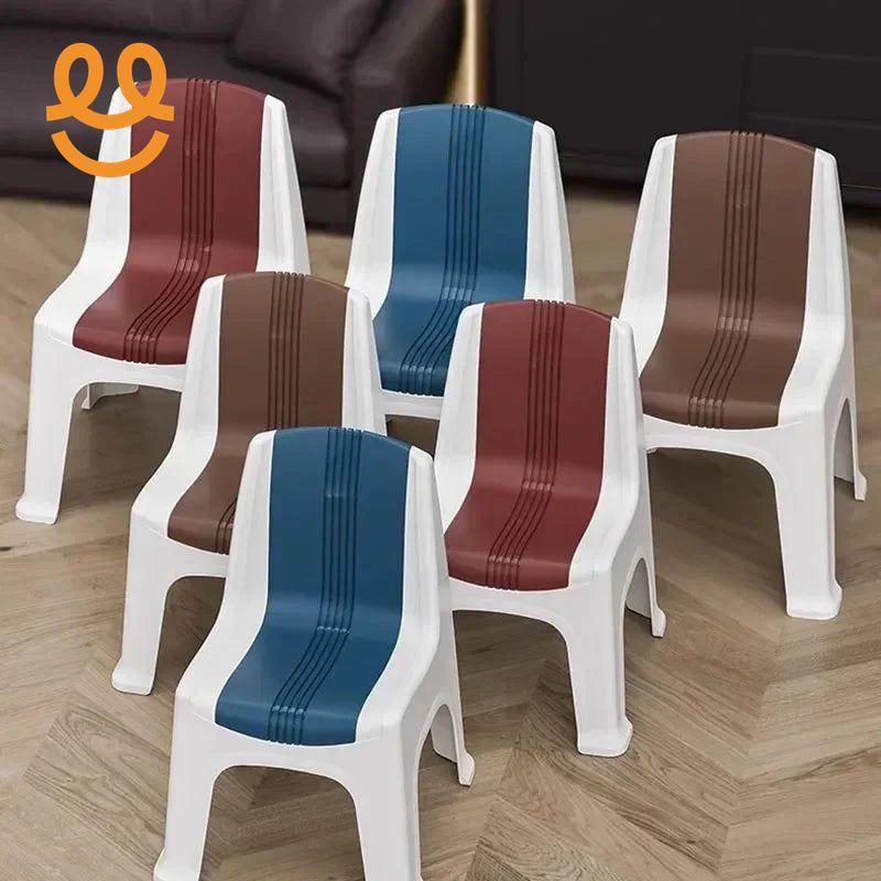 Set of six colorful plastic chairs with white frames and striped seats in blue, brown, and red on wood floor