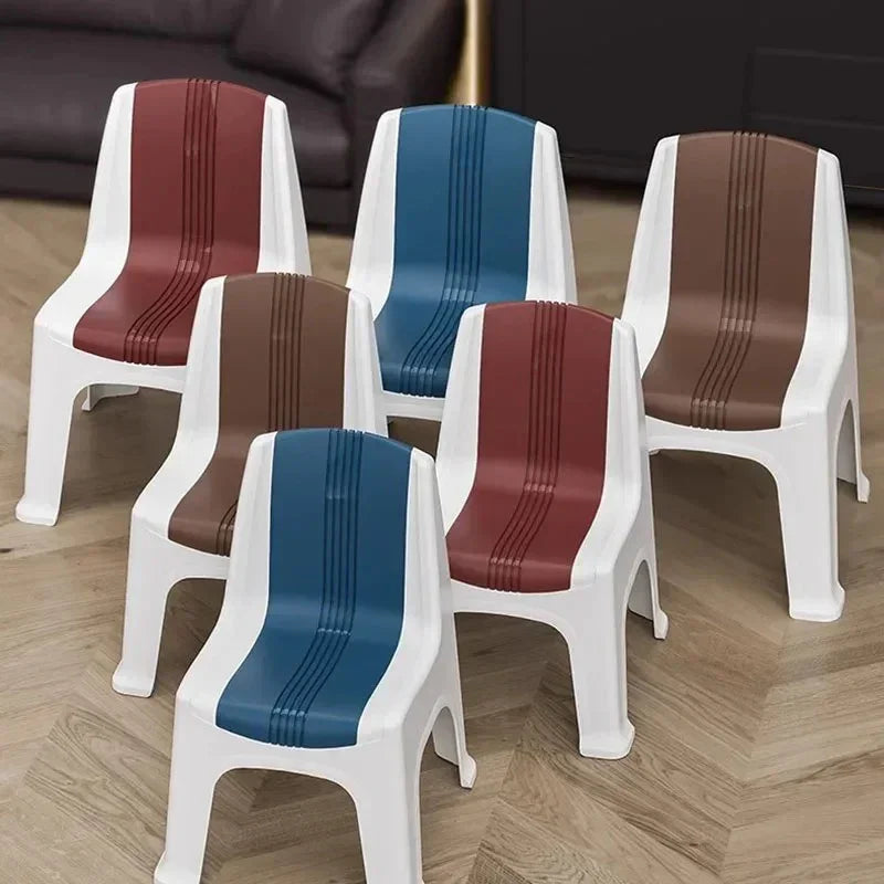 Set of six colorful plastic chairs with white frames and striped seats in blue, brown, and red on wood floor