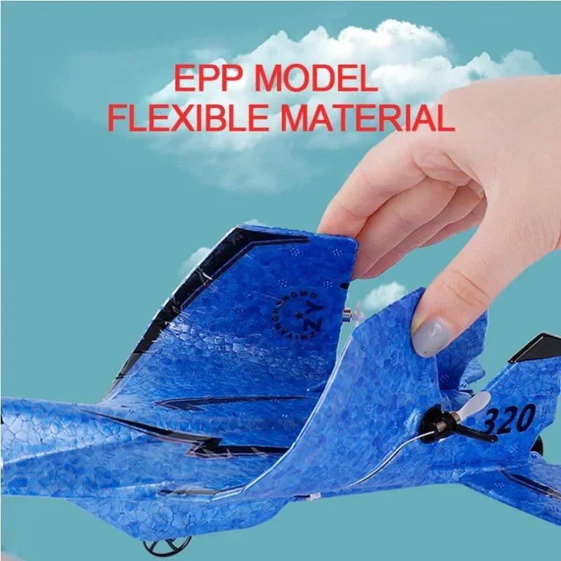 Hand squeezing flexible blue EPP model airplane wing against a cloudy sky background
