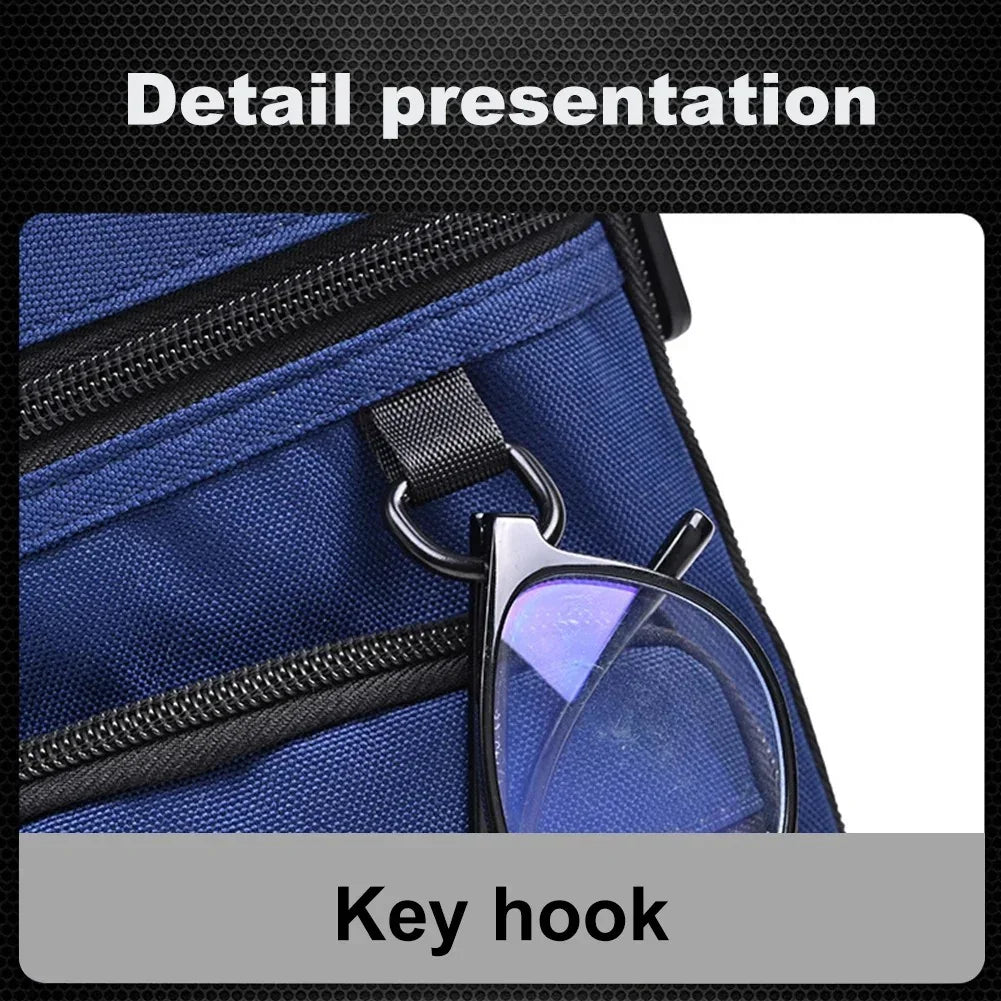 Blue backpack with black zipper and key hook holding eyeglasses close-up detail