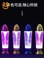 Four colorful decorative water tornado lamps with shiny metallic tops and glowing purple light