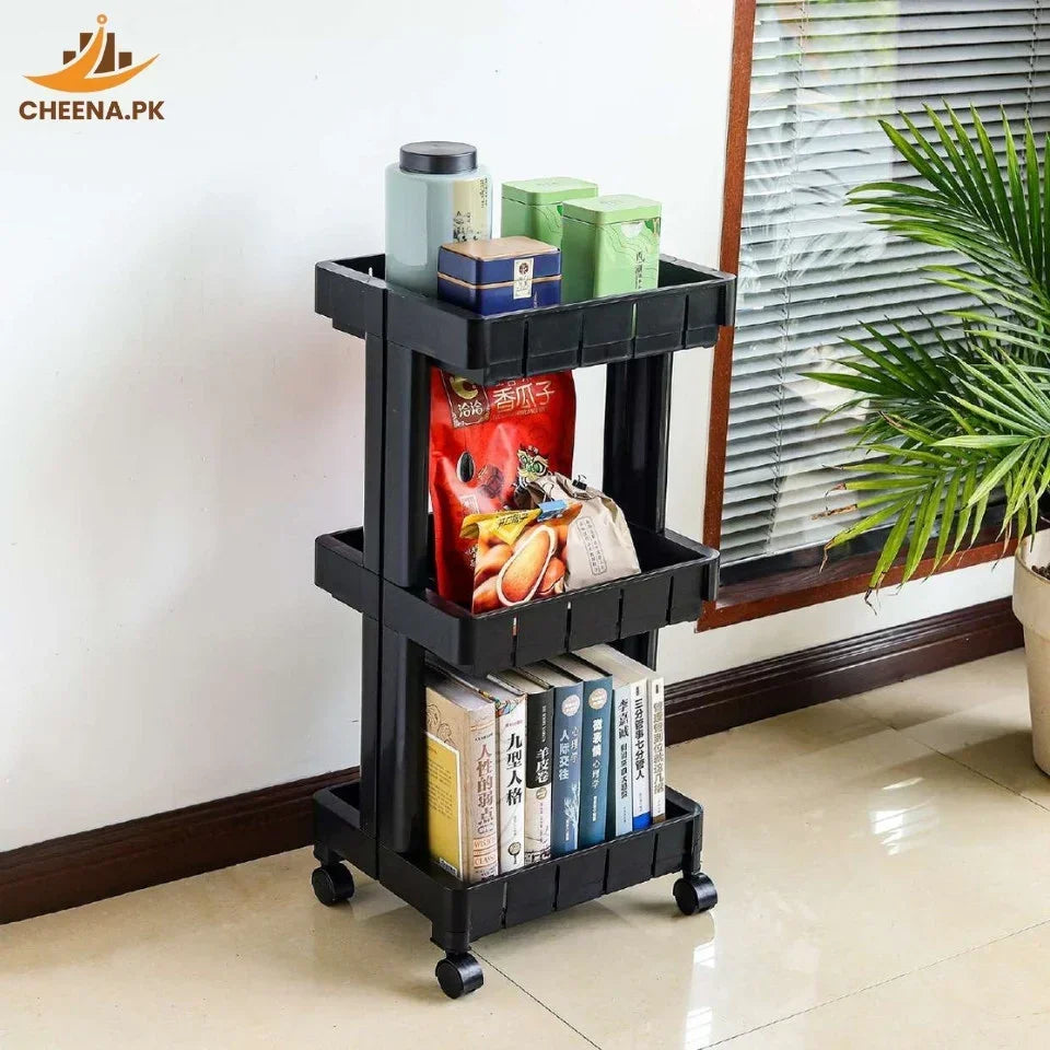 Black three-tier rolling storage cart with books, snack packs, and containers in a bright room