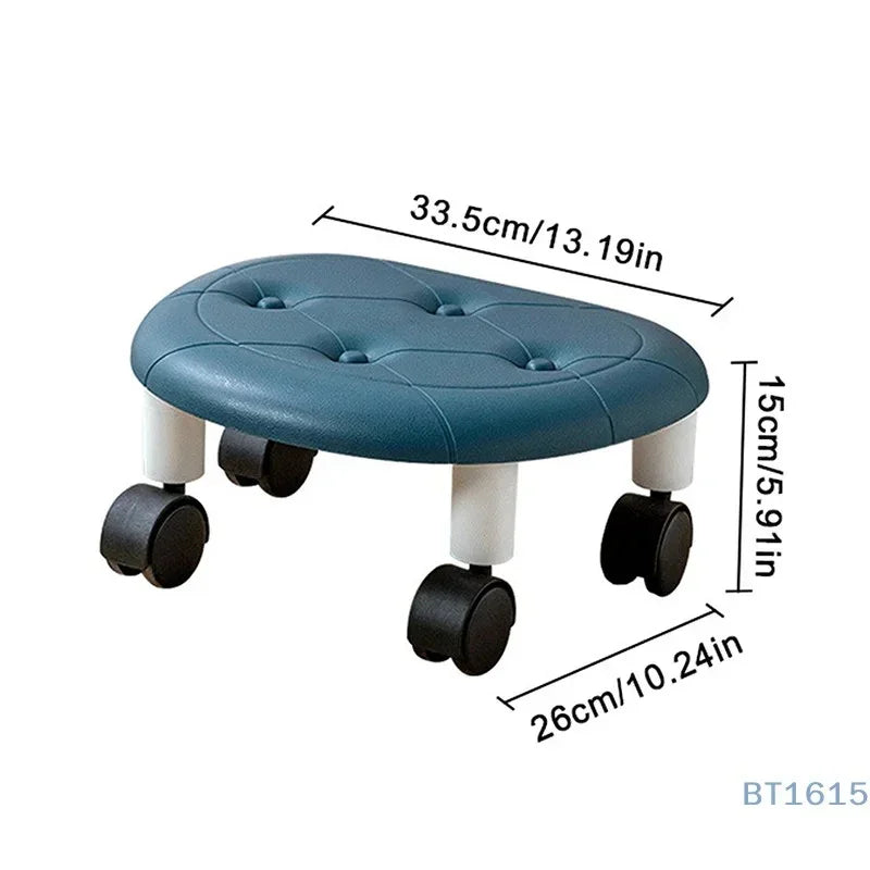 Blue cushioned footrest stool with black caster wheels and white legs, measuring 33.5x26x15 cm