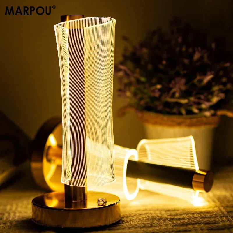 Modern LED night lamp with golden base and wavy light design on table near potted plant