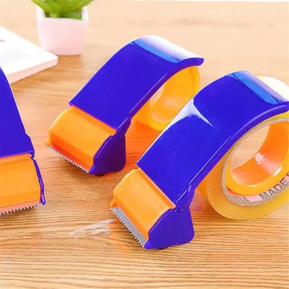 Blue and orange plastic tape dispensers on wooden surface with clear adhesive tape rolls