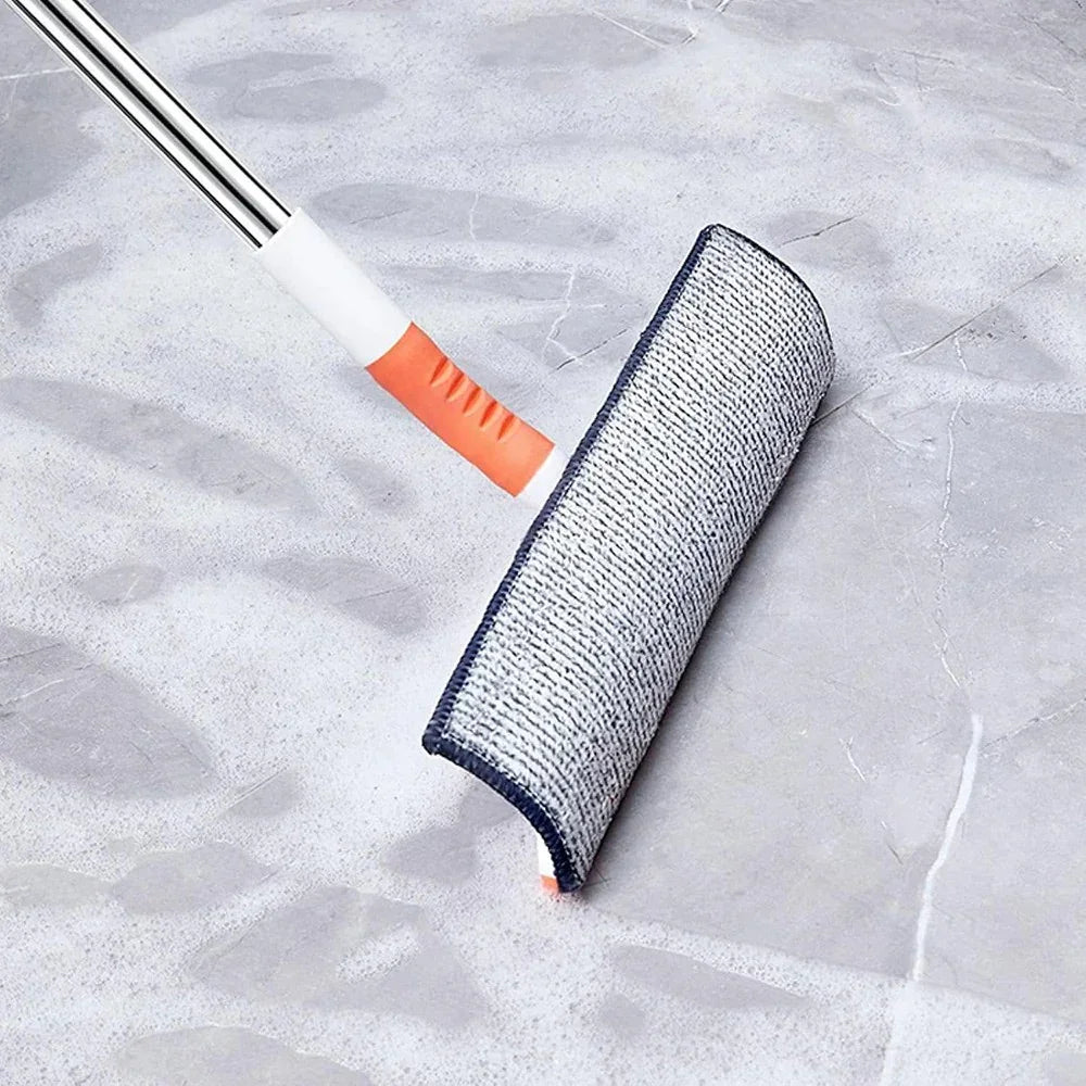 Gray and orange mop with microfiber pad cleaning soapy tiled floor
