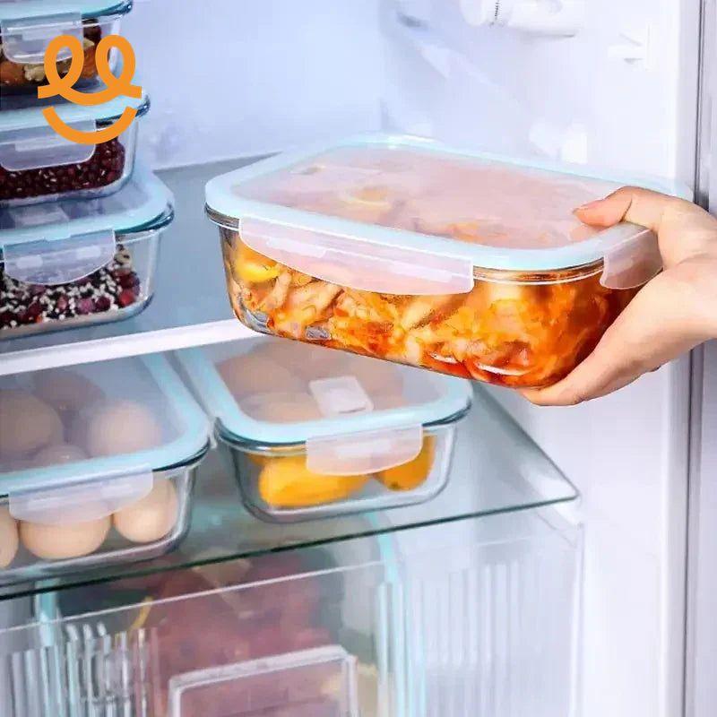 Hand placing glass food storage container with pasta in refrigerator with organized meal prep containers