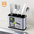Stainless steel cutlery holder with compartments containing chopsticks, forks, knife, and spoon on kitchen counter