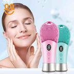 Smiling woman gently touching her face next to pink and teal silicone facial cleansing brushes with digital displays