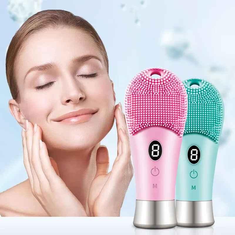 Smiling woman gently touching her face next to pink and teal silicone facial cleansing brushes with digital displays