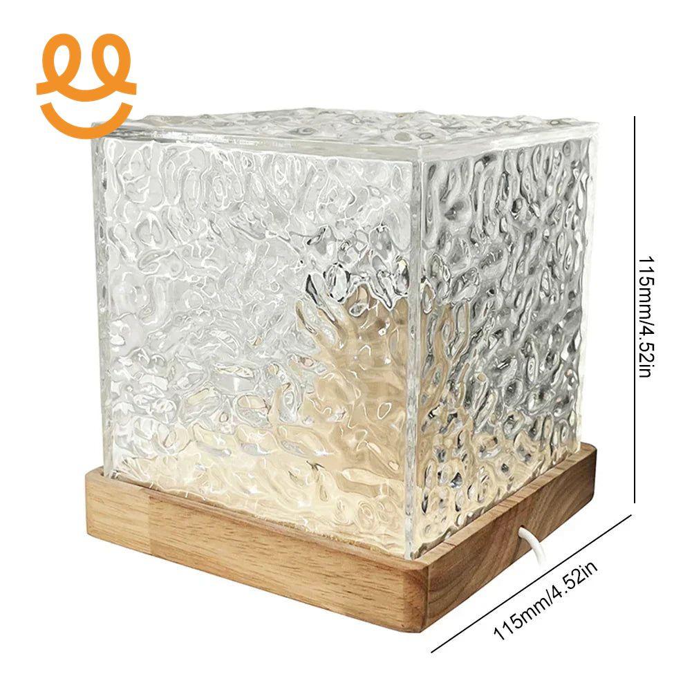 Modern textured glass cube lamp with wooden base and warm internal light