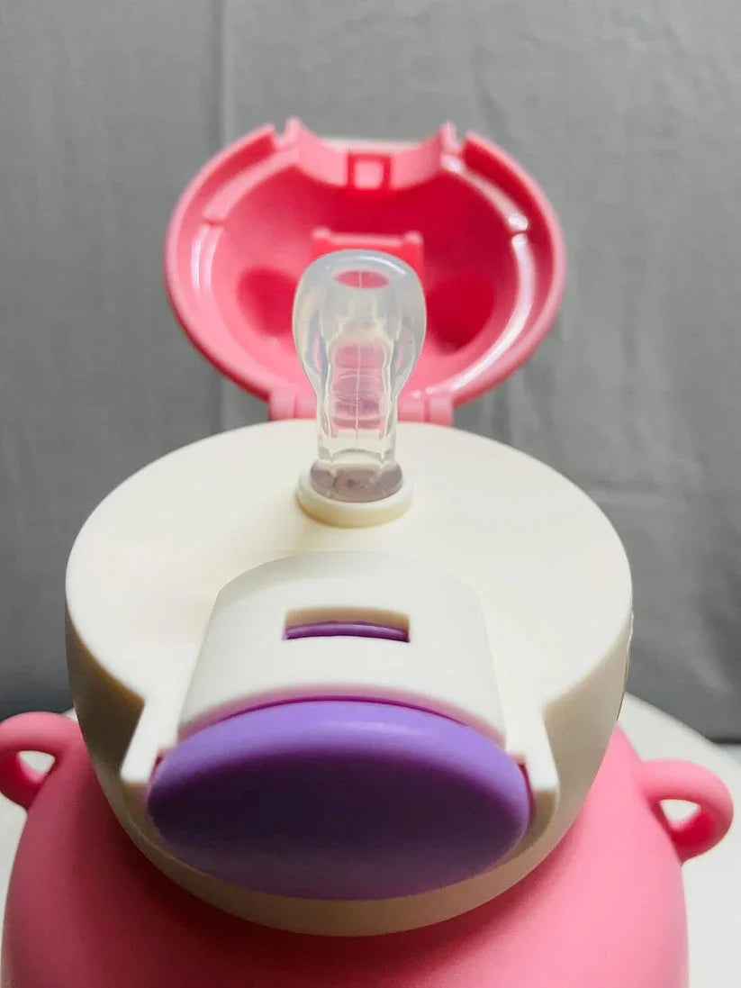 Close-up of pink and white baby bottle with clear silicone nipple and purple cap on gray background