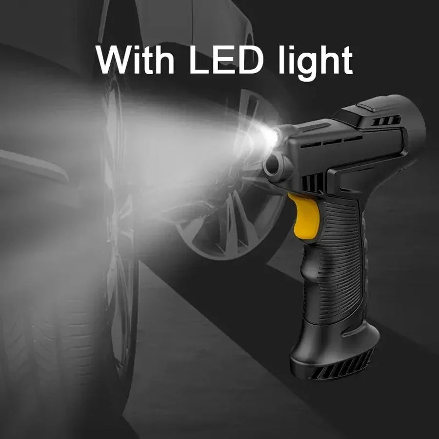 Black cordless impact wrench with yellow trigger and built-in LED light illuminating car tire