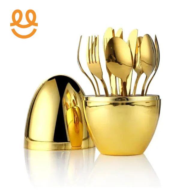 gold-plated cutlery set including forks and spoons in a matching gold container with lid