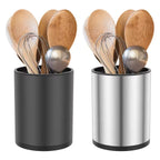 Two utensil holders, one black and one stainless steel, containing wooden spoons, metal whisk, and ladle