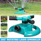 360-degree rotating lawn sprinkler in turquoise with adjustable nozzles watering green grass