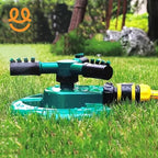 Rotating green and black garden sprinkler watering lush green grass with garden background