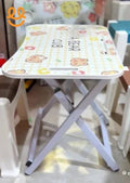 Small folding stool with white metal legs and a cushioned top featuring teddy bear and flower patterns and text A BEAR CUB