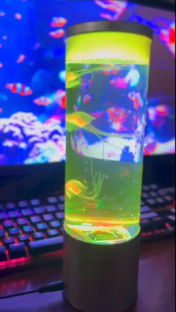Glowing neon jellyfish lamp on desk with colorful LED keyboard and digital aquarium background