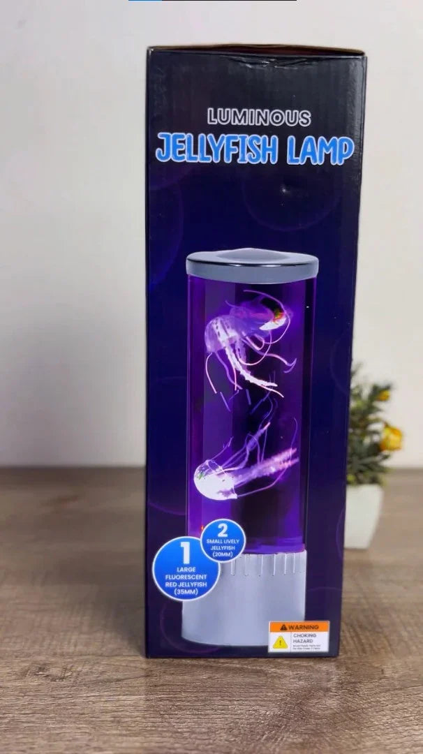 Luminous Jellyfish Lamp packaging showing 2 glowing jellyfish in purple liquid, with warning label