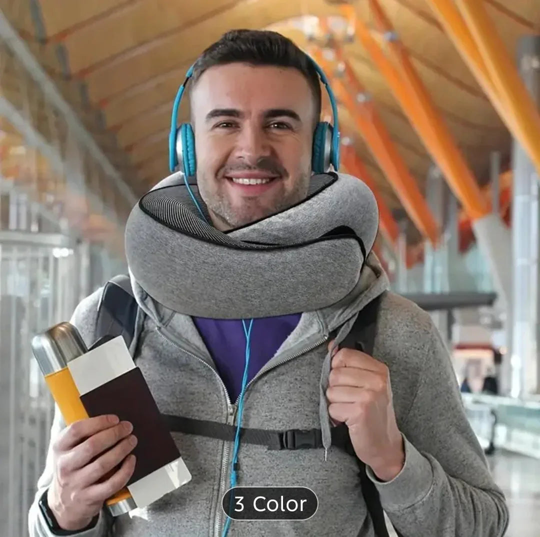Smiling man at airport with gray travel neck pillow, blue headphones, passport, and boarding pass