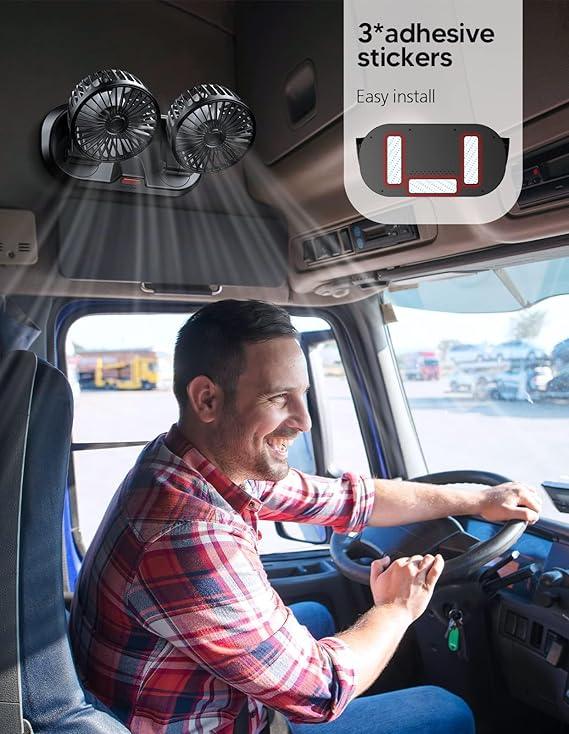 Man driving truck with installed dual black clip-on fans mounted on ceiling inside vehicle cabin