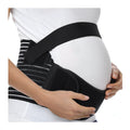 Pregnant woman wearing a black maternity support belt over a white shirt