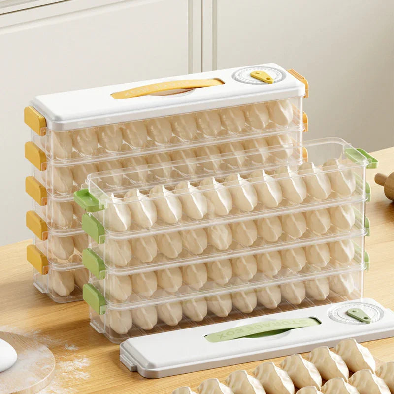 Stackable plastic storage boxes filled with rows of uncooked dumplings on wooden kitchen table