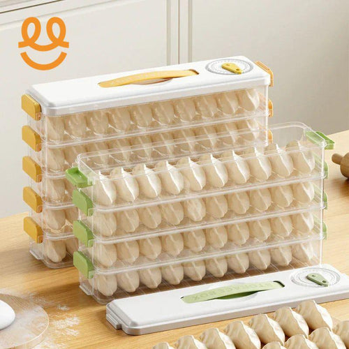 Stackable plastic storage boxes filled with rows of uncooked dumplings on wooden kitchen table