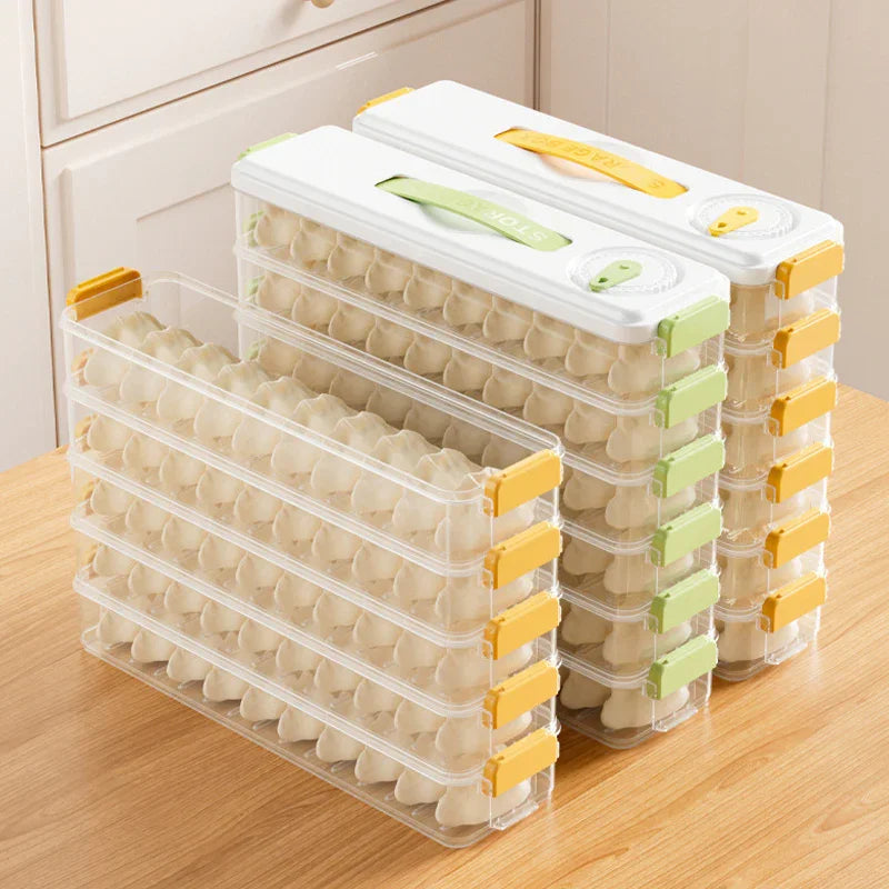 Stackable clear plastic dumpling storage containers with white lids on wooden table